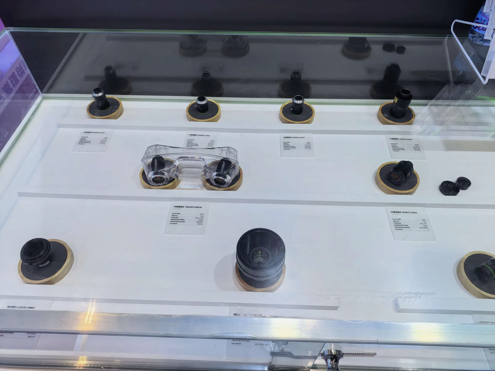 Factory-automation lens assemblies in a glass display case
