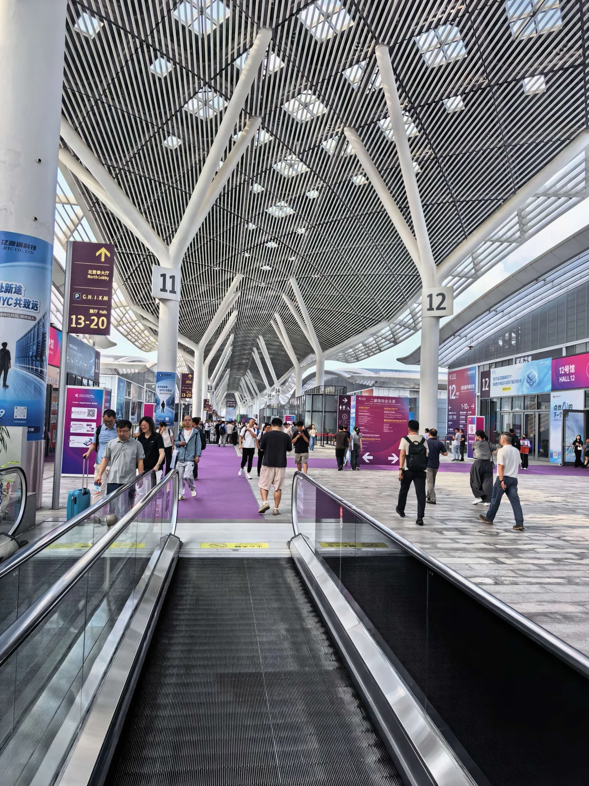 Visitors moving through the Shenzhen exhibition center concourse